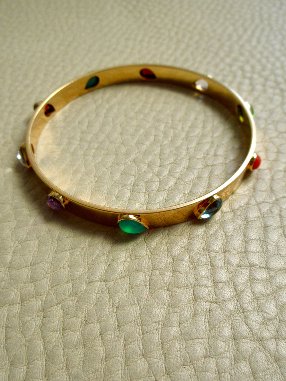 Mid-Century Danish Gemstone Bangle Bracelet 18k Gold – 7.8 Inch Circumference on beige background