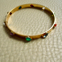 Mid-Century Danish Gemstone Bangle Bracelet 18k Gold – 7.8 Inch Circumference on beige background