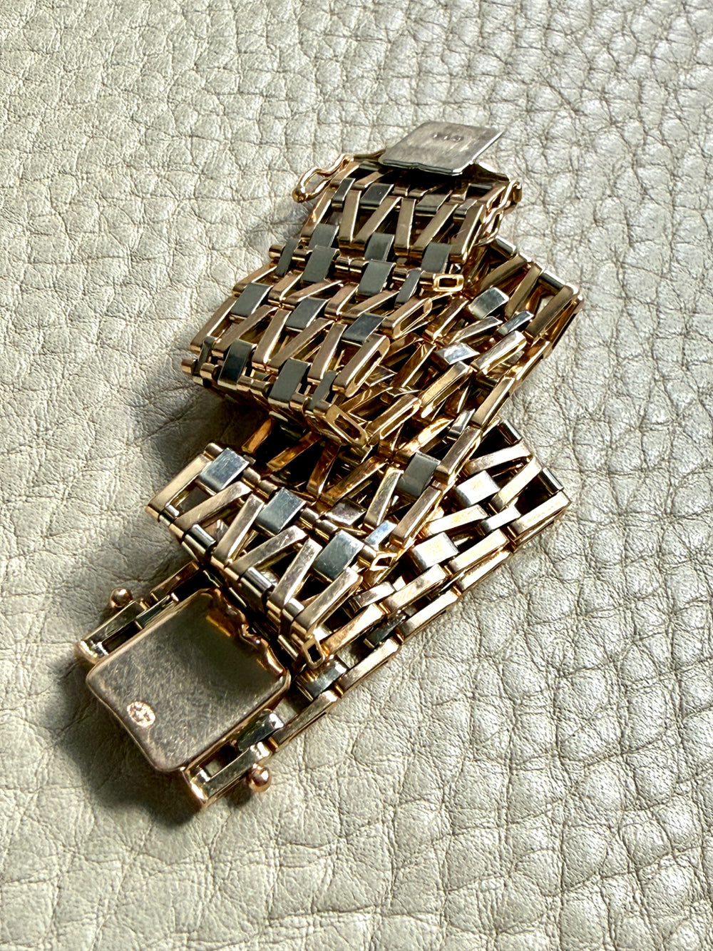 vintage 18k Gold link bracelet with a woven pattern on a textured surface