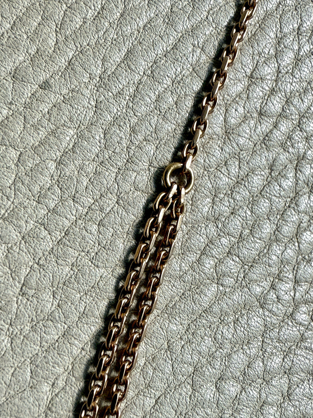 Gold chain on a textured gray surface