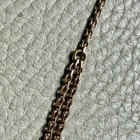 Gold chain on a textured gray surface