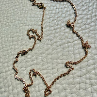 antique 18k gold chain necklace on a textured light gray surface