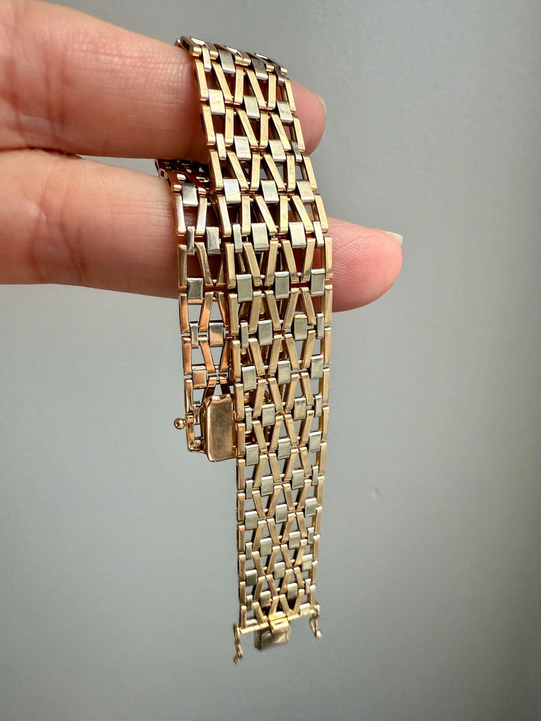 Gold bracelet held by a hand against a gray background. Penelope Penelope Vintage Gold Jewelry