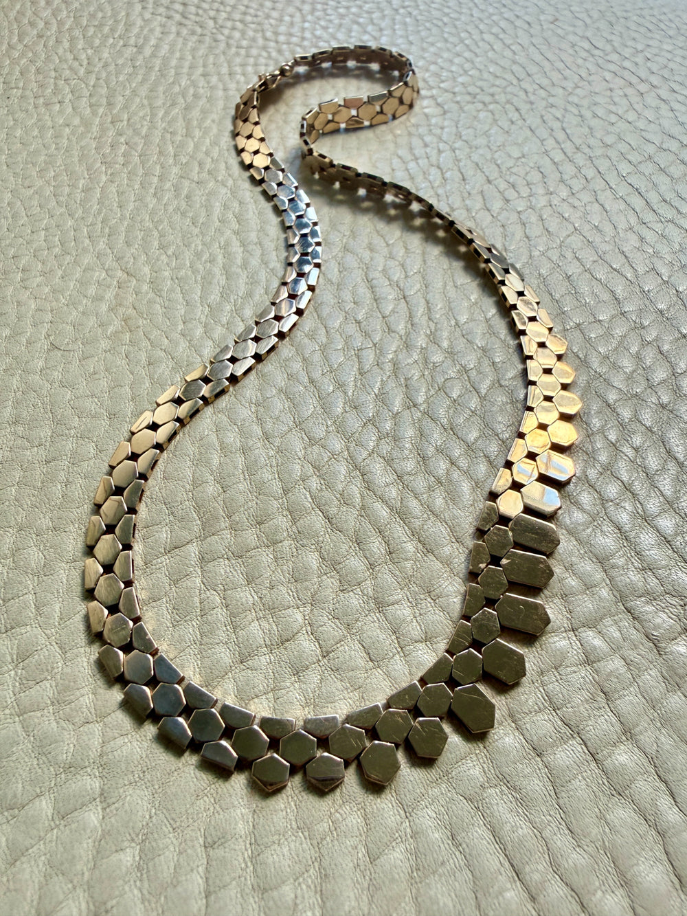 Necklace with hexagonal beads on a textured surface