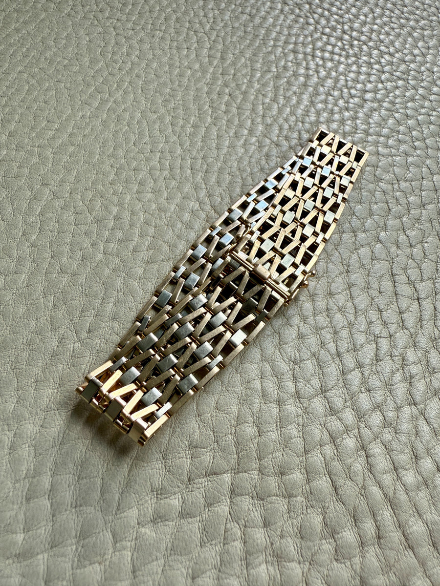 18k gold bracelet with a geometric pattern on a textured surface