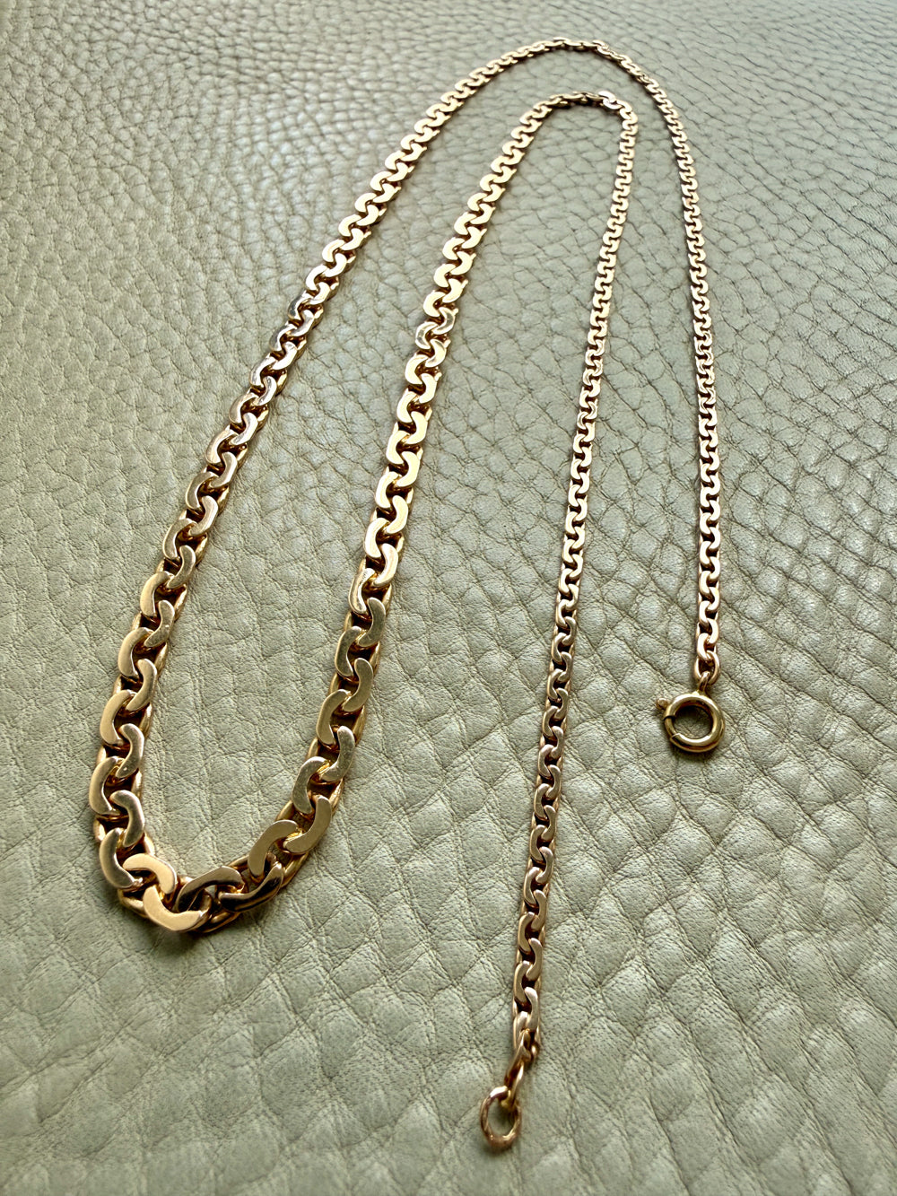 vintage 18k Gold virola link necklace on a textured light beige surface penelopepenelope.com