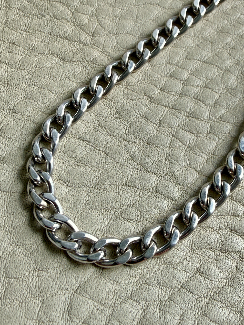 vintage 14k white gold chain necklace on a textured beige surface