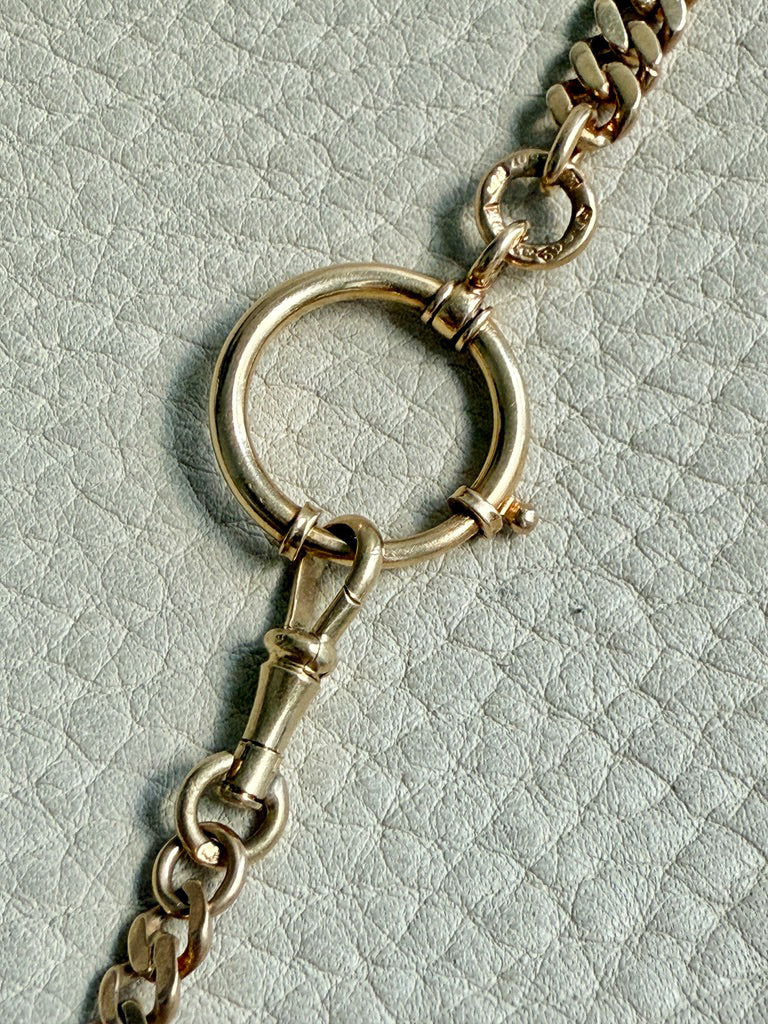 antique 18k Gold chain with a large bolt clasp on a textured light gray background. PenelopePenelope.com