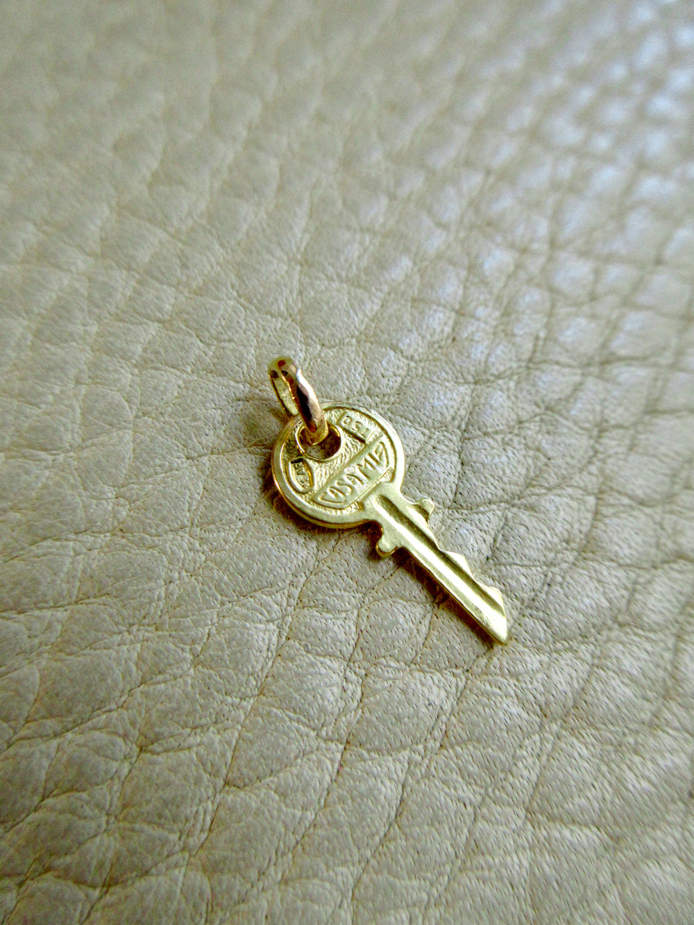 Vintage Italian Key Charm 18k Gold – Arezzo on beige background