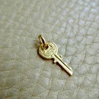 Vintage Italian Key Charm 18k Gold – Arezzo on beige background