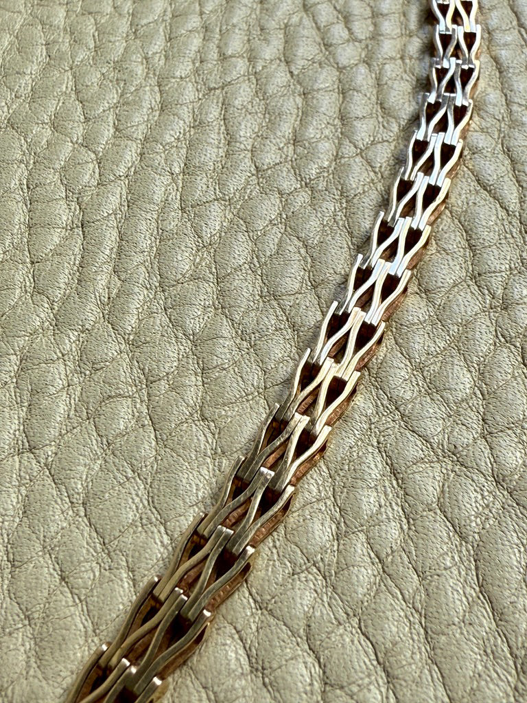 Gold chain on a textured beige background