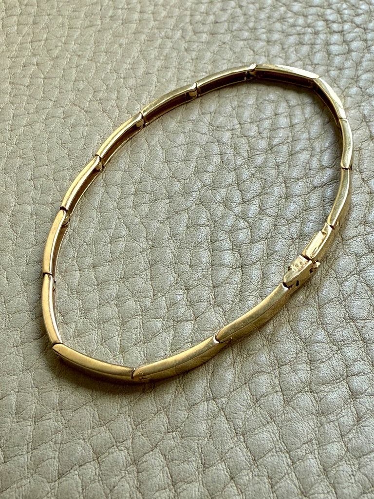 vintage 18k Gold bracelet on a textured gray surface penelopepenelope.com