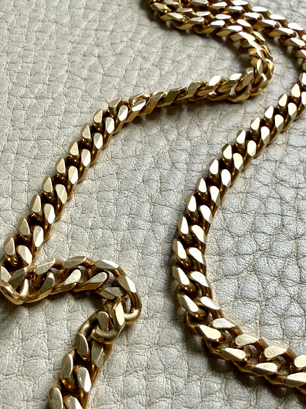 Gold chain on a textured gray surface