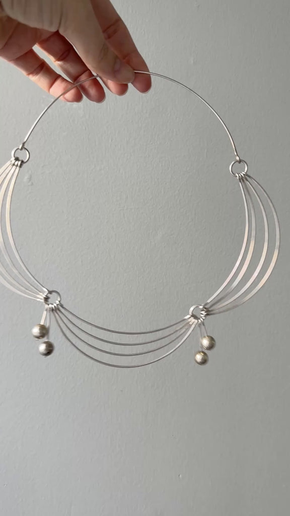 vintage silver articulated necklace in hand