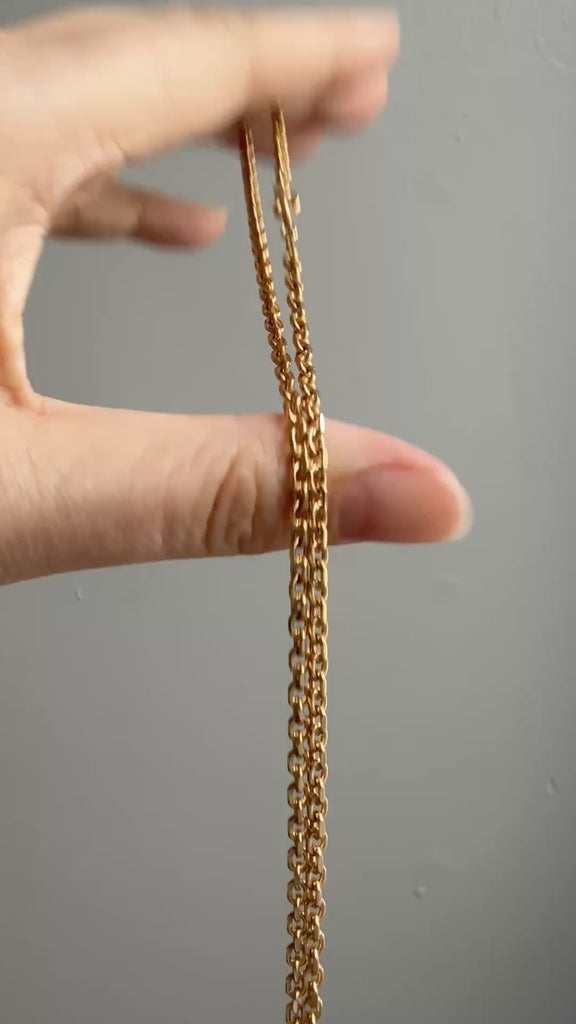 vintage gold chain moving in a person's hand
