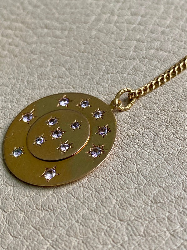 13 stone stars in circles within a solid 18k gold pendant. Hallmarks visible on jump ring