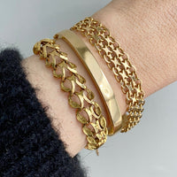 18k gold vintage swedish hinged bangle bracelet stacked with chain bracelets