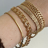 stack of 4 18k gold bracelets. One is contemporary and three are vintage bracelets from Sweden.