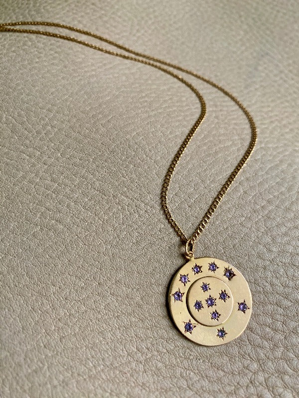 13 stone stars in circles within a solid 18k gold pendant