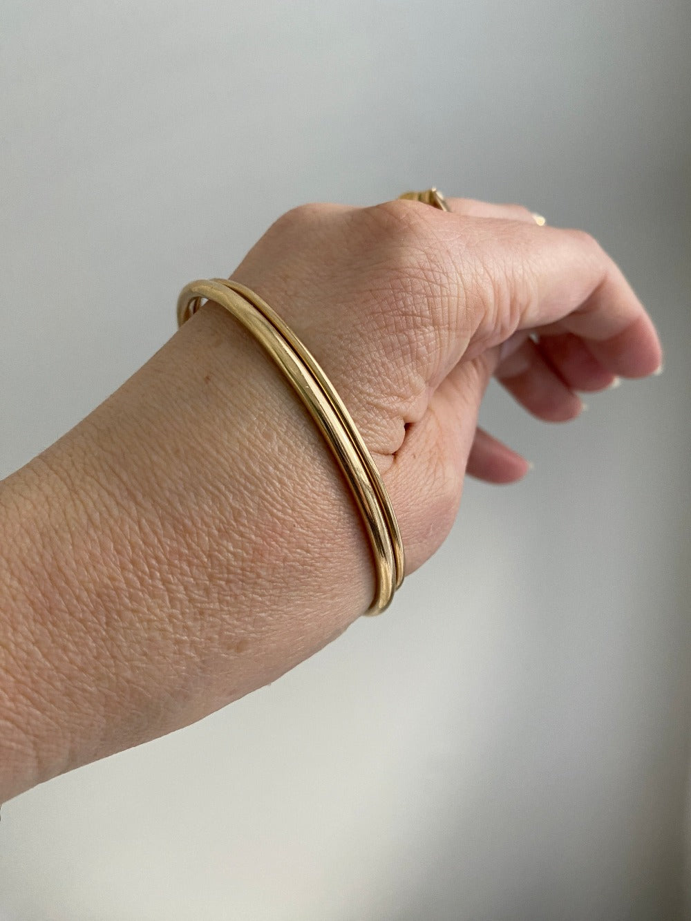 Closed bangles must fit over the widest part of your hand